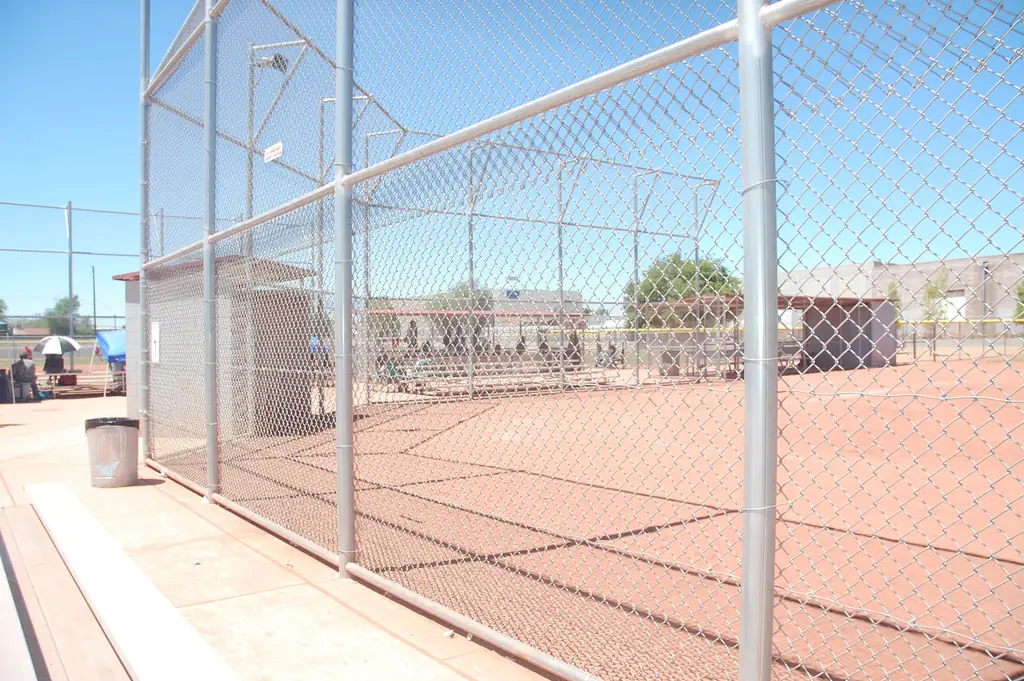 Chain link ballfield fencing installed by Albuquerque Fence Company under a clear New Mexico sky