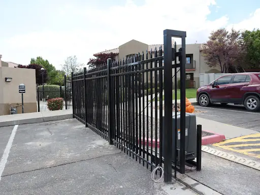 Black wrought iron sliding driveway gate with its operator, installed by Albuquerque Fence Company